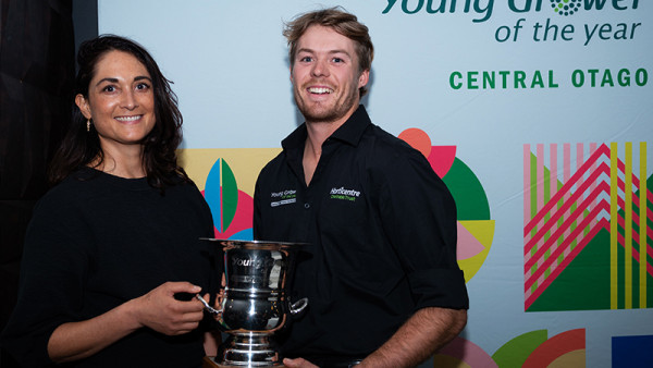 Jacob Coombridge recieving the Central Otago Young Grower trophy from HortNZ Vice-President and Director, Bernadine Guilleux.