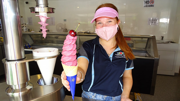 Employee, Zara Fox, delivers the ice cream with a cherry on top.